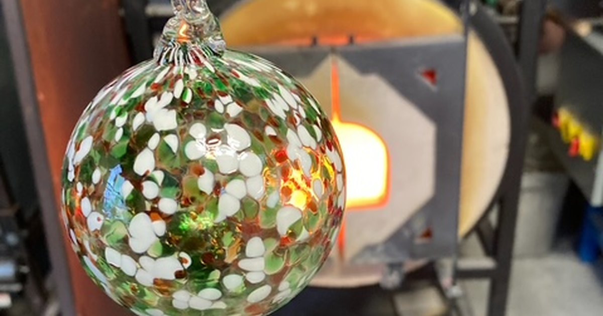 Handblown red, green, and white holiday ornament at a Salem glass studio